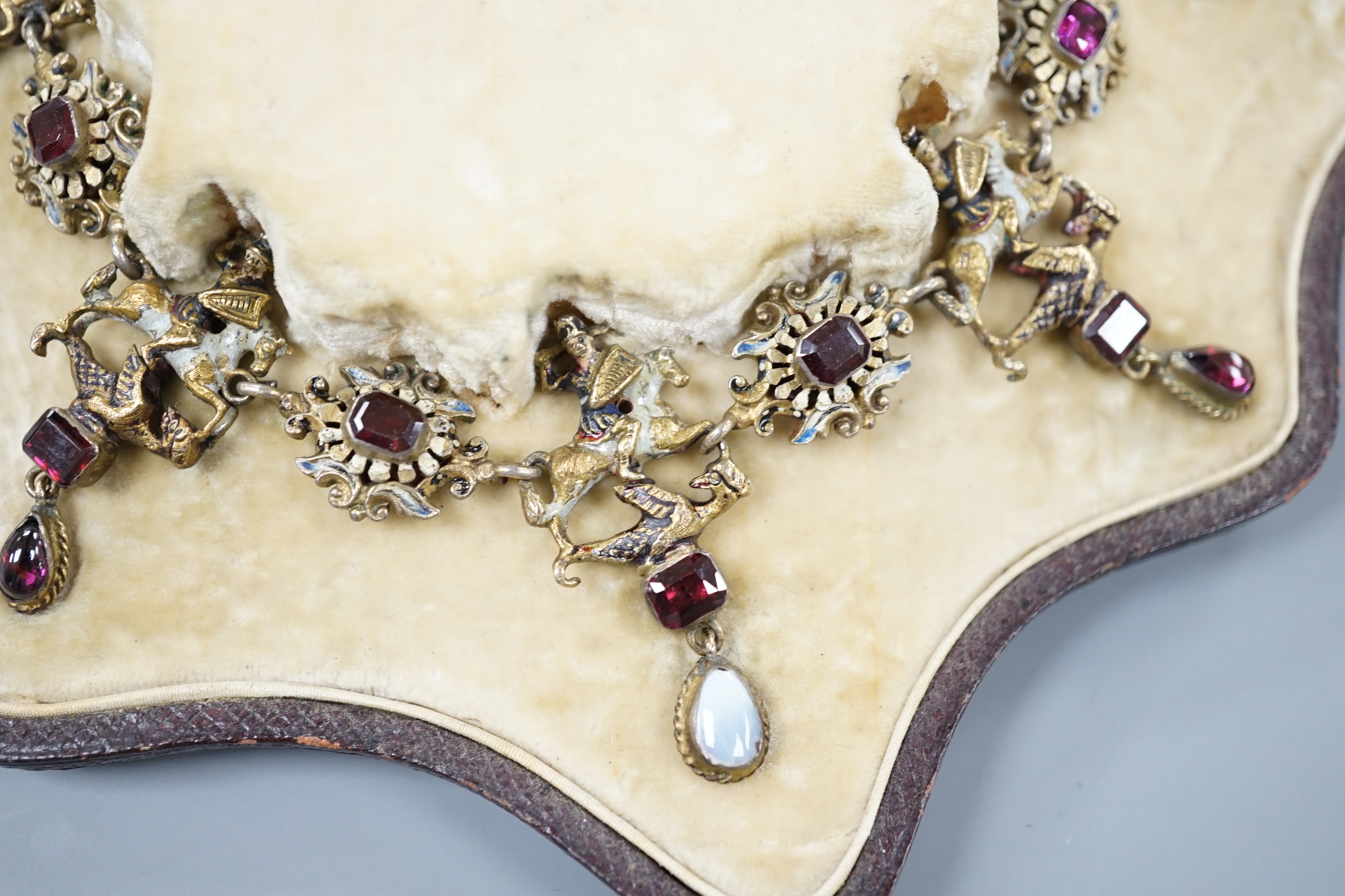A 19th century Austro-Hungarian? gilt metal, gem, enamel and paste set drop fringe necklace, 36cm, in fitted box.
